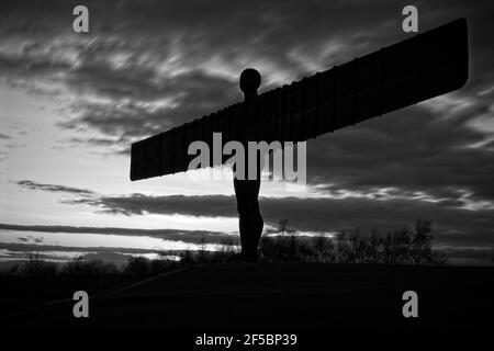 Silhouette of the Angel of the North set against a moody sky at sunset near Gateshead in North East England Stock Photo