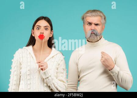 Couple with with fake mustache and lips. Having fun. Photo booth concept. Couple having fun with with fake mustache and lips. Stock Photo