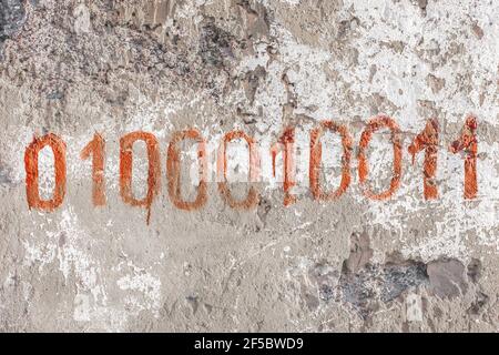 Symbols or numbers zero and one on the texture of an old white concrete wall background. Stock Photo