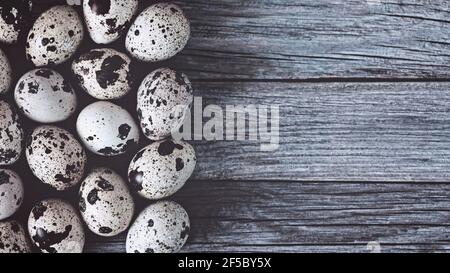 Quail eggs on wooden background, copy space Stock Photo