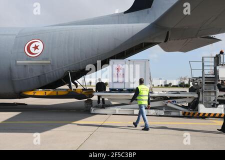 Tunis, Tunisia. 25th Mar, 2021. Airport workers unload the China-aided COVID-19 vaccine at the Carthage International Airport in Tunis, Tunisia, March 25, 2021. Tunisia received on Thursday a batch of COVID-19 vaccine donated by China and delivered aboard a military plane of the Tunisian Ministry of Defense. Credit: Adel Ezzine/Xinhua/Alamy Live News Stock Photo