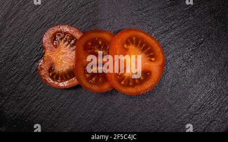 Freshly sliced tomato slices - top down view Stock Photo