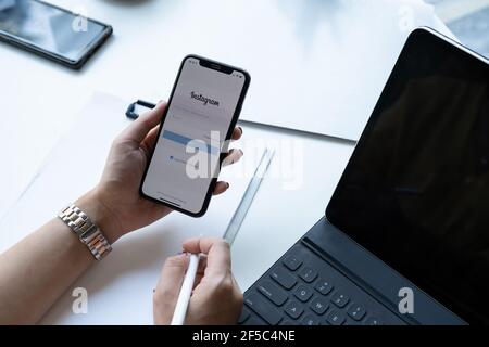 CHIANG MAI, THAILAND - NOV 07, 2020 : Woman hand holding iphone with login screen of instagram application. Instagram is largest and most popular Stock Photo