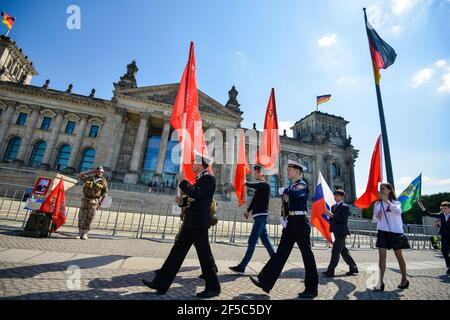 Berlin. Germany - MAY 09, 2015: Demonstration with the Soviet flag on the background Bundestag main square victory day Stock Photo