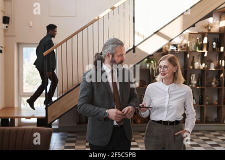 Mature business couple talking to each other they having a meeting in modern restaurant Stock Photo