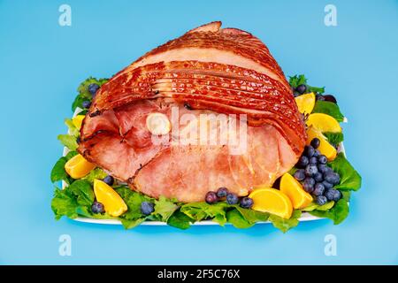 Whole pork ham with fresh fruits. Healthy food. Stock Photo