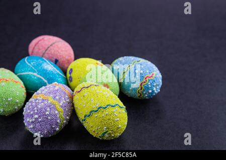 Colorful Easter eggs on a trendy black background. Stock Photo