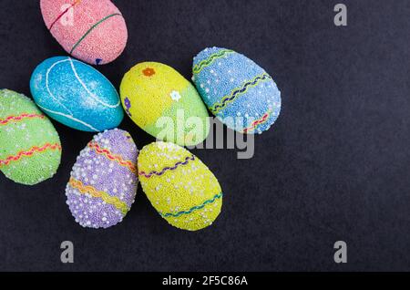 Colorful Easter eggs on a trendy black background. Stock Photo