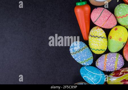 Colorful Easter eggs and other objects on a trendy black background for various Easter themed backgrounds Stock Photo