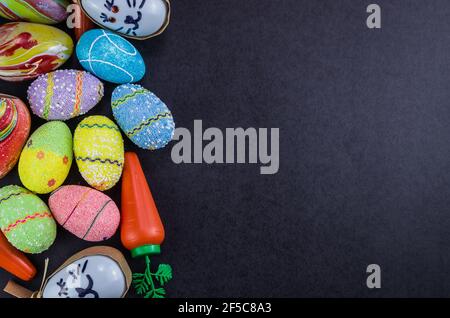 Colorful Easter eggs and other objects on a trendy black background for various Easter themed backgrounds Stock Photo