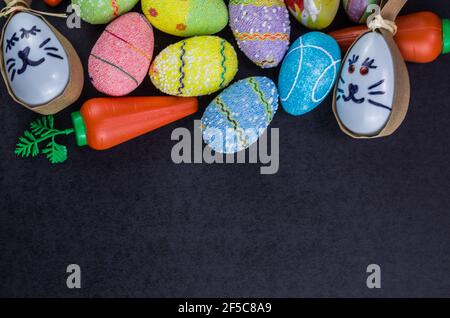 Colorful Easter eggs and other objects on a trendy black background for various Easter themed backgrounds Stock Photo