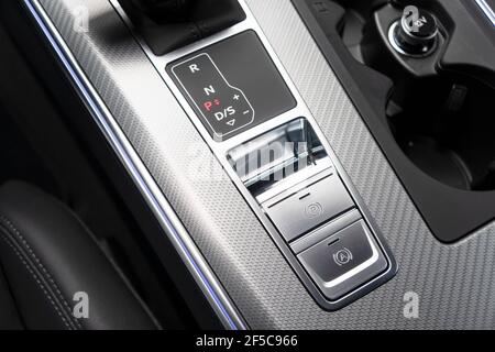 Detail of a parking brake in a nodern car. Electronic parking brake button in a modern car. Button closeup. Stock Photo