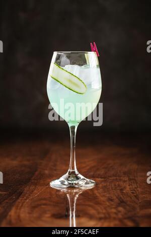 Cloudy cucumber on wooden table with reflection Stock Photo