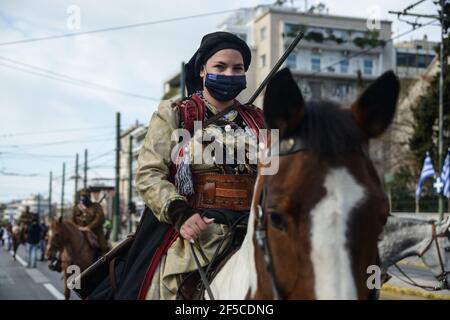 Female cavalry fighter wearing traditional costume of the Greek revolution 1821. Bicentenary Independence Day Military Parade in Athens. Stock Photo