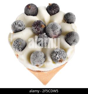 Ice cream in a waffle cone with black currant berries isolated on a white background. Stock Photo