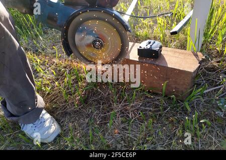 Cutting bricks with an angle grinder, construction work, the process of execution close-up.new Stock Photo