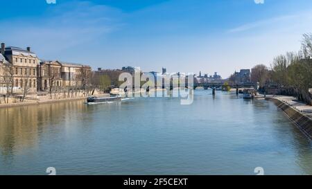 Paris, the Pont des Arts on the Seine, beautiful panorama with houseboat, and the Saint-Jacques tower in background Stock Photo