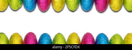 Foil wrapped chocolate Easter egg borders. Stock Photo