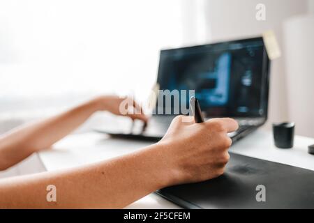 A female hands drawing on a tablet. Close up. Freelance and creative work. Stock Photo