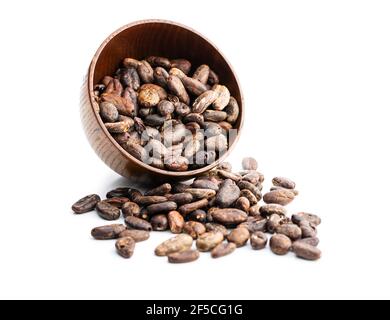 Roasted cocoa beans in bowl isolated on white background. Stock Photo