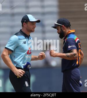 England's captain Jos Buttler, left, and teammates attend a training