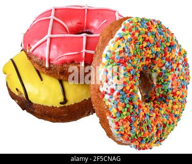 Donuts in strawberry, banana glaze and multicolored confectionery sprinkles isolated on white background. Stock Photo