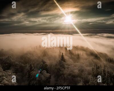 Magnificent view from Watchtower in the mountains during the winter. Land covered by snow, peace in soul during amazing sunset. Stock Photo