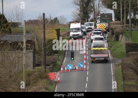 Workmen install a fiber-optic cable under a rural road outside Lisburn, Northern Ireland, UK Stock Photo