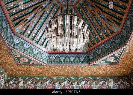 Beautiful large chandelier on the ceiling in a traditional oriental style with many details and ornaments. Stock Photo