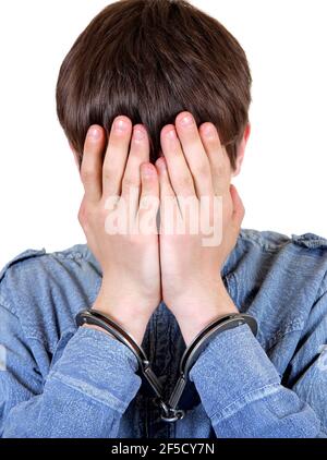 Troubled and Sorrowful Young Man in Handcuffs on the White Stock Photo