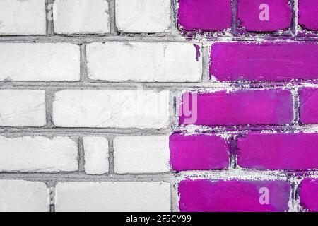 Old white dirty brick art wall design texture with purple paint background. Stock Photo