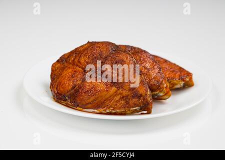 Seer fish fry arranged beautifully on awhite ceramic plate with white textured background,isolated. Stock Photo