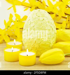 Easter decoration eggs and candles with tulips Stock Photo