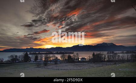 aurora over the Chiemsee with the Fraueninsel and the Alps at New Years morning, Germany, Bavaria, Lake Chiemsee Stock Photo