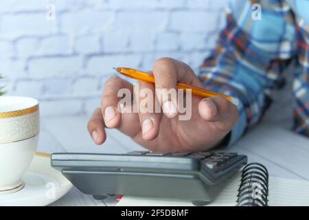 Close up of man hand using calculator  Stock Photo
