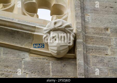 CHRISTCHURCH, ENGLAND – MARCH 26 2021: New stone carving of a masked PPE NHS Worker commemorating or celebrating the Covid 19 Pandemic NHS work, lands Stock Photo