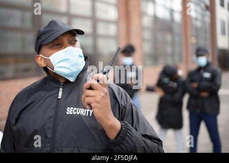 African American Security Officer At Event In Face Mask Stock Photo