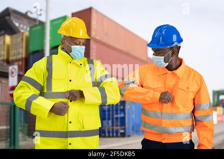 Construction Engineer Elbow Bump Wearing Covid Mask Stock Photo