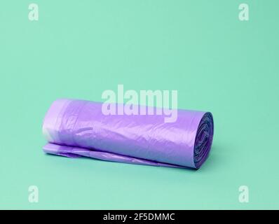 skein of purple plastic trash bags with strings isolated on white  background, close up Stock Photo - Alamy