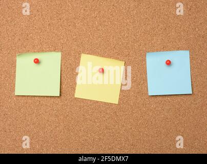 square blank pieces of paper pinned on a cork board, copy space Stock Photo