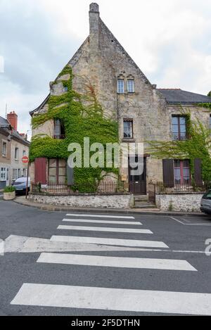 A zebra crossing and an ancient Ivey covered house in the pretty town of Azay-le-Rideau Stock Photo