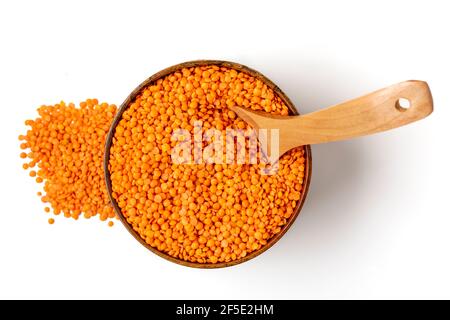 Raw seeds of orange lentils in wooden bowl, spoon isolated on white background Top view Flat lay Healthy eating, vegetable protein concept Traditional Stock Photo