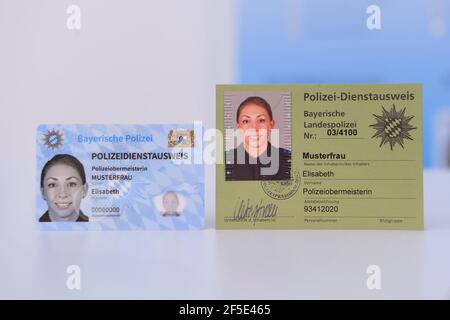 26 March 2021, Bavaria, Roding: Sample copies of the new (left) and old Bavarian police service ID cards, taken at a press event. After 35 years, the old green service cards will be replaced by a new, particularly forgery-proof card in credit card format. Photo: Tobias Hase/dpa Stock Photo