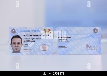 26 March 2021, Bavaria, Roding: Front and back of sample copies of the new Bavarian police service ID card, taken at a press event. After 35 years, the old green service cards will be replaced by a new, particularly forgery-proof card in credit card format. Photo: Tobias Hase/dpa Stock Photo