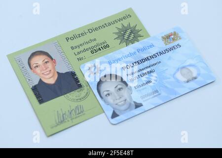 26 March 2021, Bavaria, Roding: Sample copies of the new (right) and old Bavarian police service ID cards, taken at a press event. After 35 years, the old green service cards will be replaced by a new, particularly forgery-proof card in credit card format. Photo: Tobias Hase/dpa Stock Photo