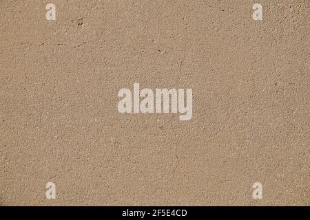 The surface of the concrete wall: slightly cracked, in warm beige color. Stock Photo