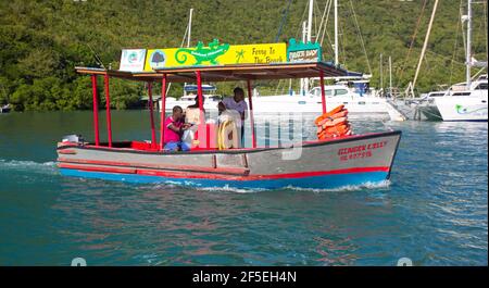 Marigot Bay, Castries, St Lucia. Colourful ferry from LaBas Beach approaching the quay. Stock Photo