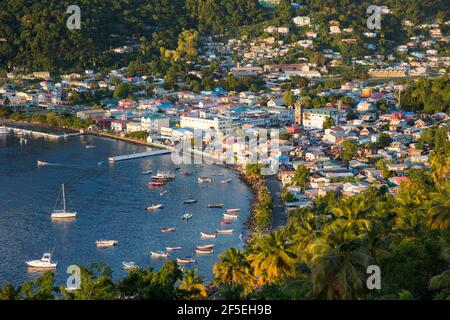 Soufriere, St Lucia. View over the town and harbour from hilltop mirador, colourful buildings lit by the setting sun. Stock Photo