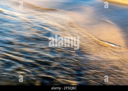 abstract landscape of sea. texture water and sand in blurry motion in the golden hour Stock Photo