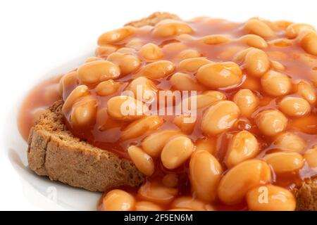 Detail of baked beans in tomato sauce on toast. Stock Photo